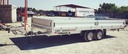Two-axle car trailer with adjustable towbar