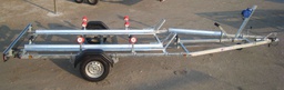Custom trailer for one boat and two motorcycles transport